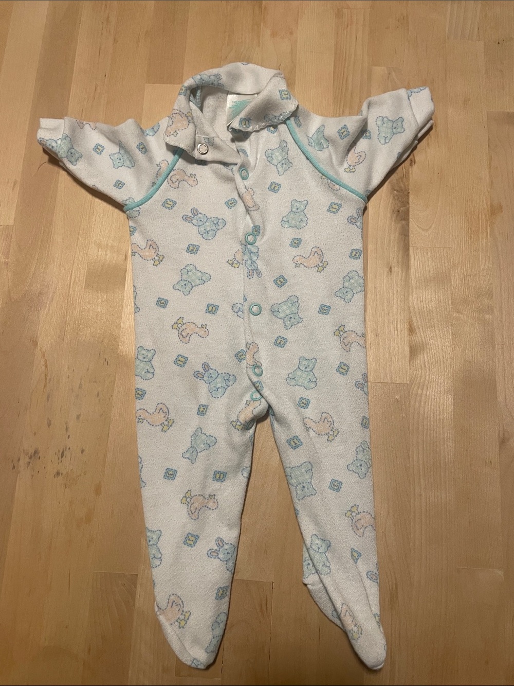 Cream Footed Baby One-Piece with Pastel Blue Trim and Animal Print